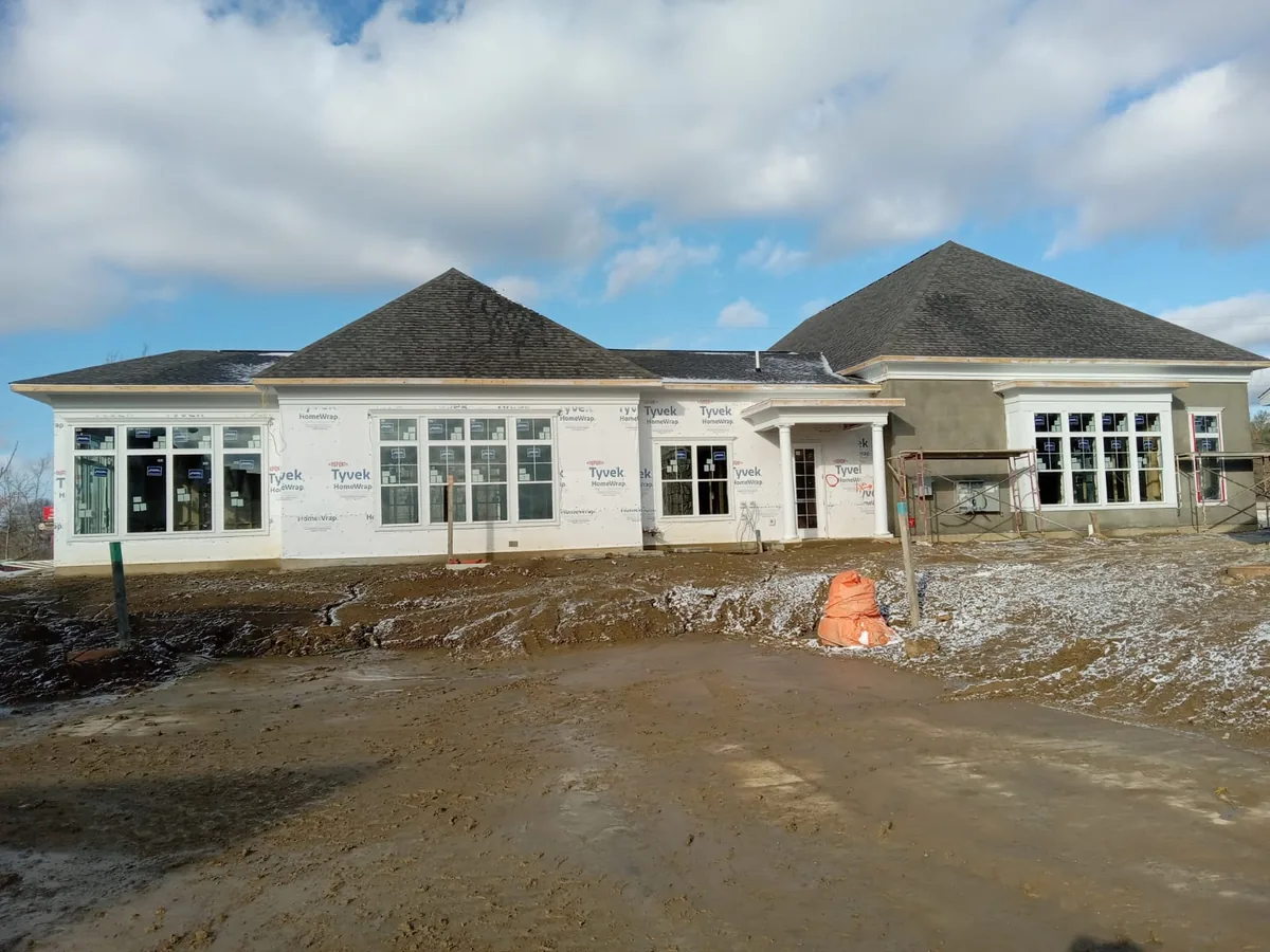 Commercial building under construction with house wrap and new roof