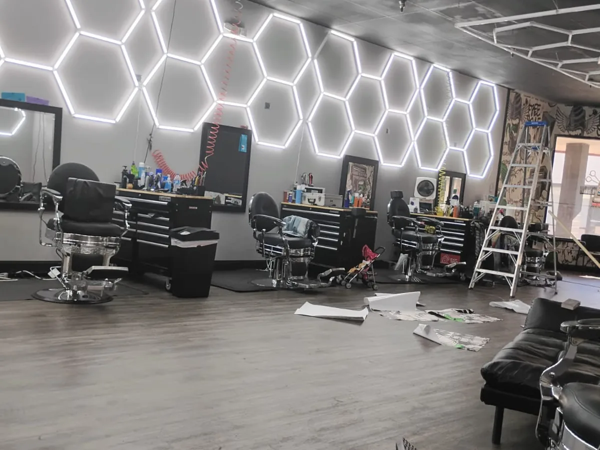 Finished barbershop build-out with hexagon LED ceiling lighting