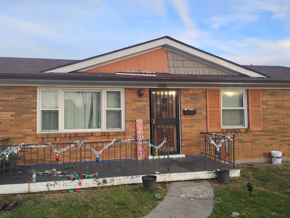 Brick house with a rebuilt front porch and painted trim